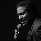 black and white photo of Greg Walker singing